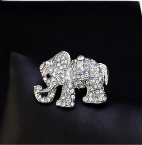 Macro view of silver elephant brooch with sparkling rhinestones and colorful crystals