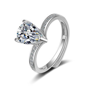 Minimalist silver open ring featuring a pear-cut cubic zirconia and small side stones