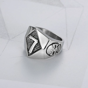 Macro detail of men's stainless steel ring featuring skull relief and number 7 design