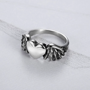 Vintage stainless steel ring featuring a heart with detailed angel wings in silver finish