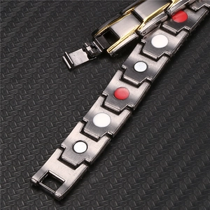 Detailed close-up of dark grey magnetic therapy link bracelet with red and white stones