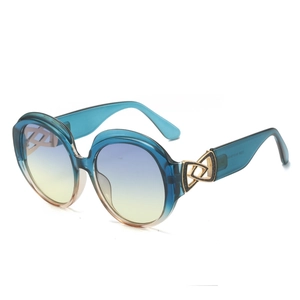 Occhiali da sole rotondi oversize con lenti sfumate blu-giallo e finitura dorata