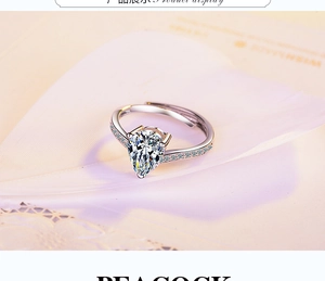 Detail of adjustable silver ring with pear-cut zircon on soft pink feathers and lace