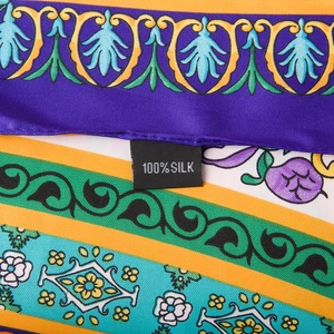 Detail shot of the 100% silk material label on a floral pattern twill satin scarf