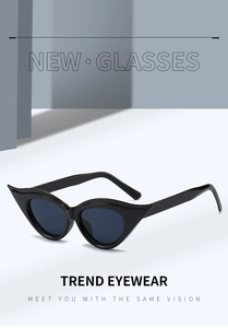 Close-up of trendy black cat-eye sunglasses with dark blue lenses and sharp angles