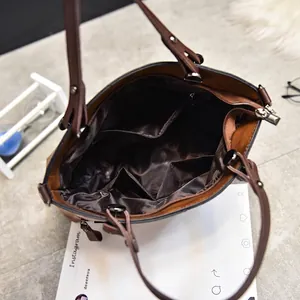 Deep brown tote bag interior featuring smooth satin lining and multiple storage pockets