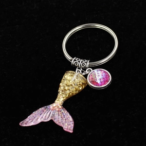 Golden mermaid tail keychain with gradient pink glitter and round fish scale charm