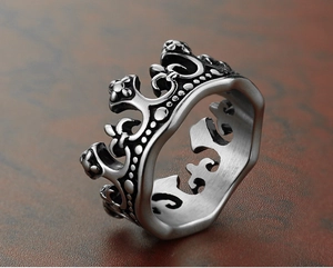 Macro shot of vintage crown ring showing embossed iris details and aged steel finish