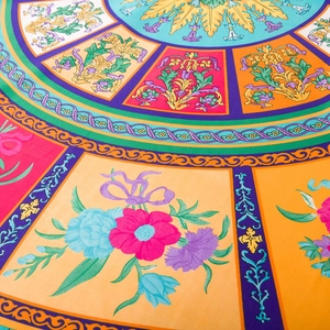 Detailed macro view of vibrant baroque floral silk satin scarf fabric with intricate patterns