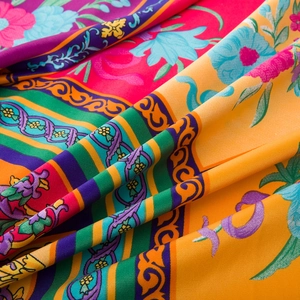 Close-up of luxury floral twill satin scarf fabric showing colorful intricate patterns