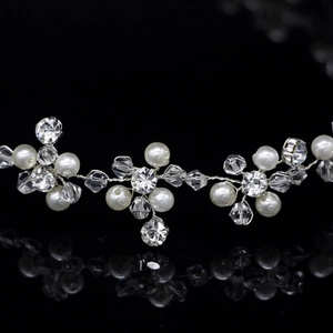 Handmade bridal hair vine with faux pearls and crystals on a silver wire and black background
