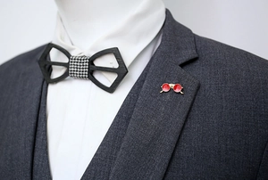 Detail of red round lens sunglasses brooch pinned on a grey suit lapel for men