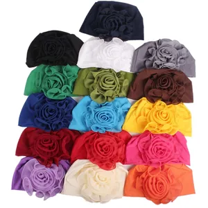Elegant multi-color elastic turban hats for women featuring large decorative floral accents