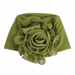 Detail of elegant olive green turban hat featuring a large multi-layer fabric flower design
