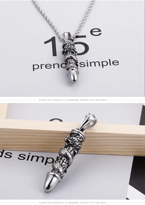 Detail of silver retro dragon pillar pendant with 3D embossed texture and braided rope chain