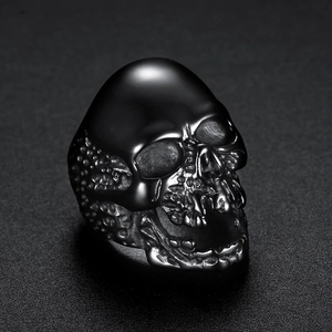 Detailed close-up of a vintage skull ring in gun black finish with gothic punk metal texture