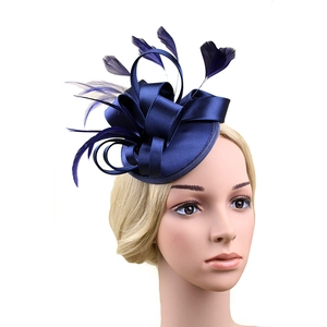 Detail of navy blue fascinator hat with satin bow and feathers on mannequin