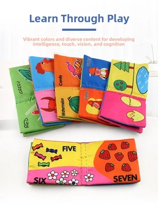 Close-up of baby cloth books showing colorful fruit and number themes for early learning
