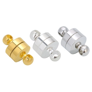 Close-up of gold and silver magnetic cylinder clasps for jewelry making DIY