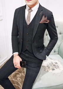 Detail of trendy enamel sunglasses brooch pinned on a black plaid formal suit jacket