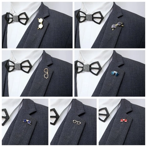 Detailed views of various sunglasses-shaped enamel pins on a classic suit lapel