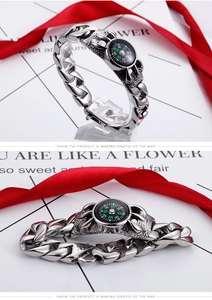 Detailed view of men's chunky chain bracelet with functional compass and dragon engravings