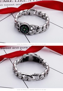 Close-up of vintage steel chain bracelet with a working compass and claw design