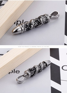 Detailed close-up of bullet pendant featuring intricate Chinese dragon relief engraving