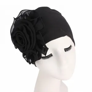 Close-up of large chiffon flower detail on elastic black headscarf turban cap
