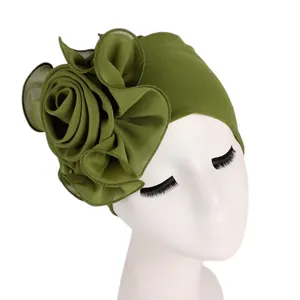 Detail view of large olive green chiffon floral ornament on an elastic turban cap