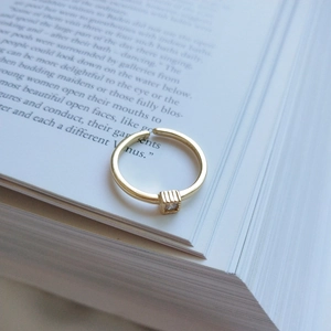 Close-up of S925 sterling silver frosted gold ring with square cubic zirconia stone