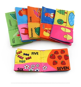 Detail of colorful cloth books for babies showing numbers, fruits and occupation patterns