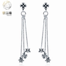 Silver tassel earrings featuring cross motifs and stars with polished metal chains