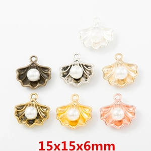 Dettaglio di ciondoli a conchiglia con perle in varie finiture metalliche, 15x15x6mm
