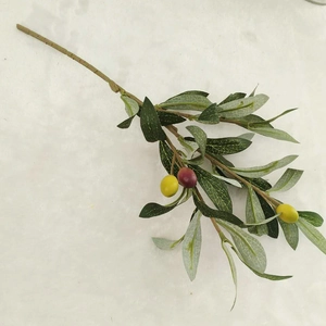 Close-up of artificial olive branch with realistic green leaves and colorful fruits