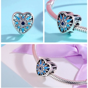 Detailed views of 925 silver heart charm with blue enamel evil eye and sparkling crystals