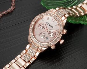 Close-up of rose gold Geneva watch with diamond bezel and pink sunray dial detail