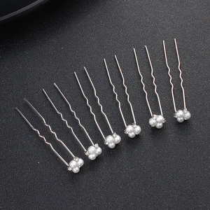 Set of 6 minimalist silver U-shaped bridal hair pins with white pearls on black background