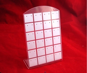L-shaped acrylic earring holder with 30 holes on a red velvet background