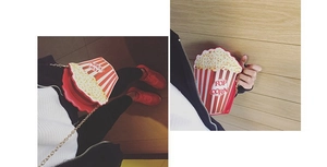 Close-up of red and white striped popcorn box shoulder bag with gold chain strap detail