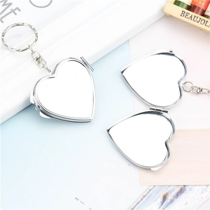 Silver heart-shaped metal folding mirrors showing both open and closed states
