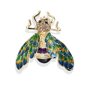 Macro shot of bee brooch with colorful enamel wings and sparkling rhinestones