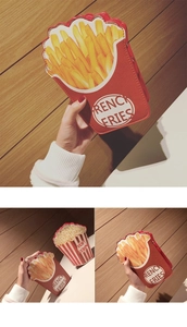 Detailed close-up of creative French Fries and Popcorn shaped crossbody bags held in hand