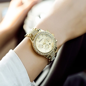 Elegant gold Geneva women's watch with rhinestone bezel and steel calendar wristband