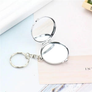Mini silver round folding mirror with metal keychain and double-sided clear reflections