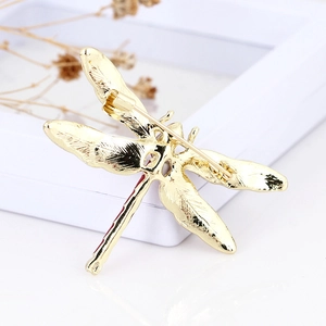 Golden enamel dragonfly brooch with rhinestones showing back safety pin and wing texture