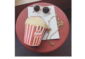 Popcorn shaped crossbody bag with red and white stripes and gold chain strap
