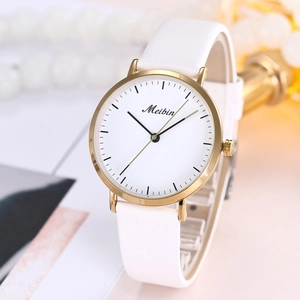 Detail of elegant gold case watch with white dial and white leather strap