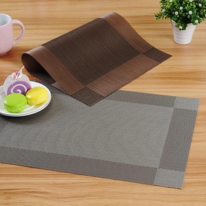 European woven PVC placemats in bronze and gray on wood table with dessert scene