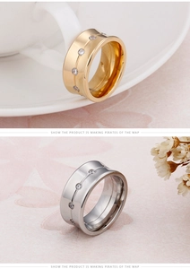 Detail view of 10mm wide gold and silver stainless steel rings with sparkling cubic zirconia